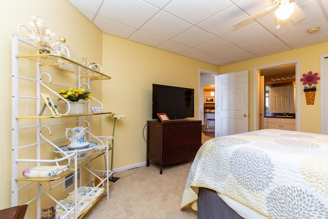 bedroom featuring carpet flooring, ensuite bathroom, and ceiling fan