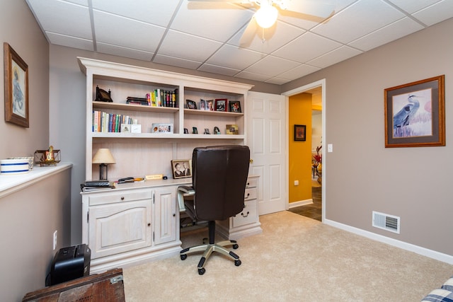 office area featuring light carpet, a paneled ceiling, and ceiling fan