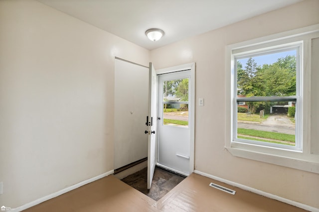 doorway with hardwood / wood-style flooring and plenty of natural light