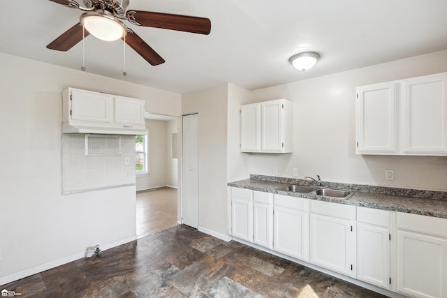 kitchen featuring white cabinetry and sink