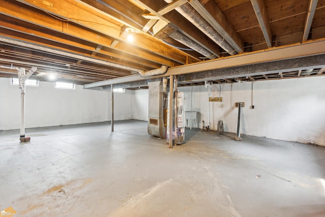 basement featuring sink and heating unit