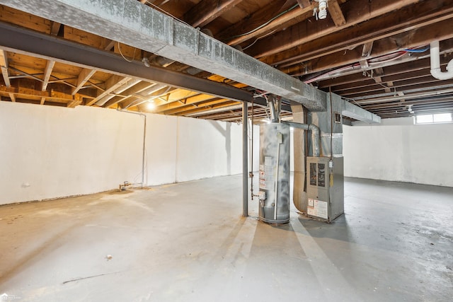 basement featuring heating unit and water heater