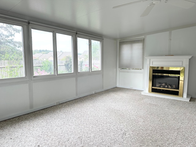 unfurnished living room with carpet flooring and ceiling fan