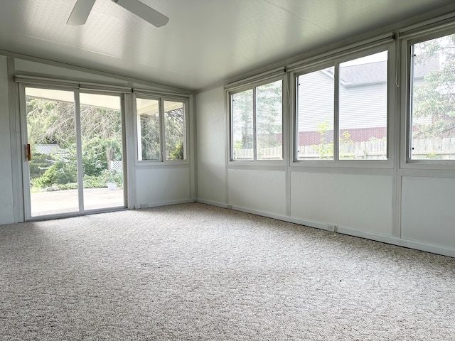 unfurnished sunroom with vaulted ceiling, a wealth of natural light, and ceiling fan