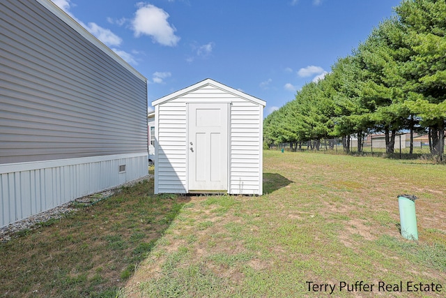 view of outbuilding with a lawn