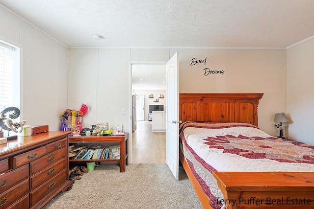 carpeted bedroom featuring crown molding and a textured ceiling