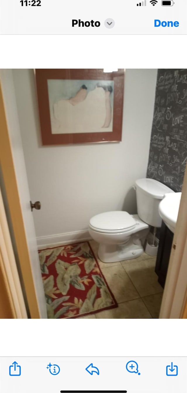 bathroom with toilet and tile patterned floors