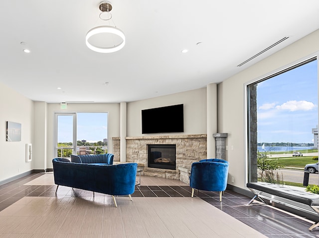 living room with a fireplace and dark wood-type flooring