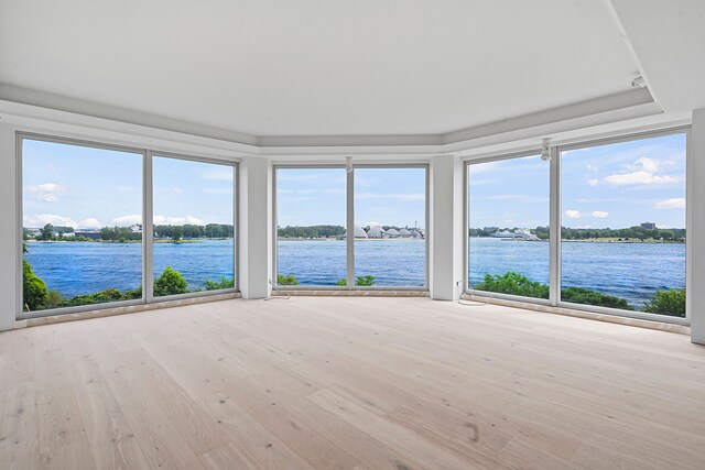 201 Beers St Unit 53, Port Huron, MI 48060 - unfurnished sunroom with a water view, a raised ceiling, and wood finished floors
