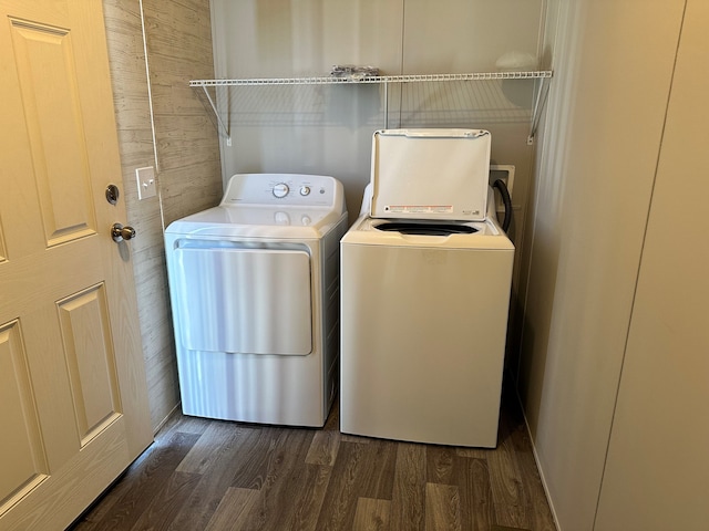 16678 Lakewood Dr, Holly, MI 48442 - laundry area with washer and dryer, dark wood-type flooring, and wood walls