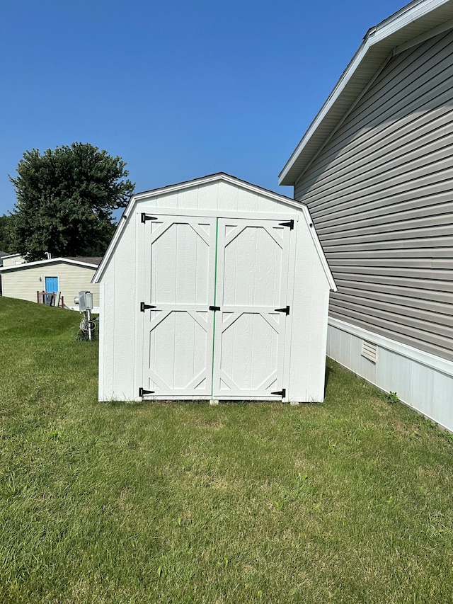 view of outbuilding with a yard