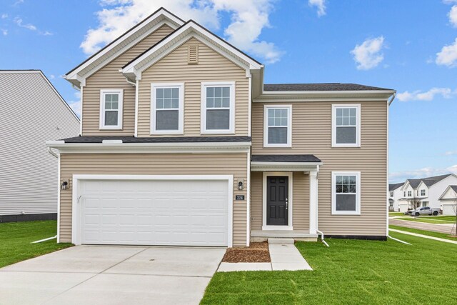 view of front of home with a front yard and a garage