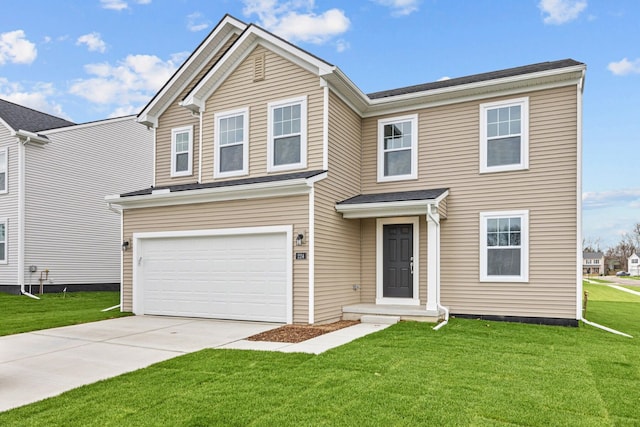 view of front of home with a front yard and a garage