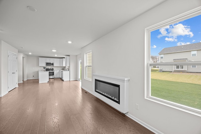 unfurnished living room with dark hardwood / wood-style floors