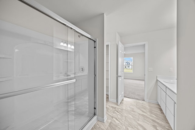 bathroom featuring vanity and a shower with shower door