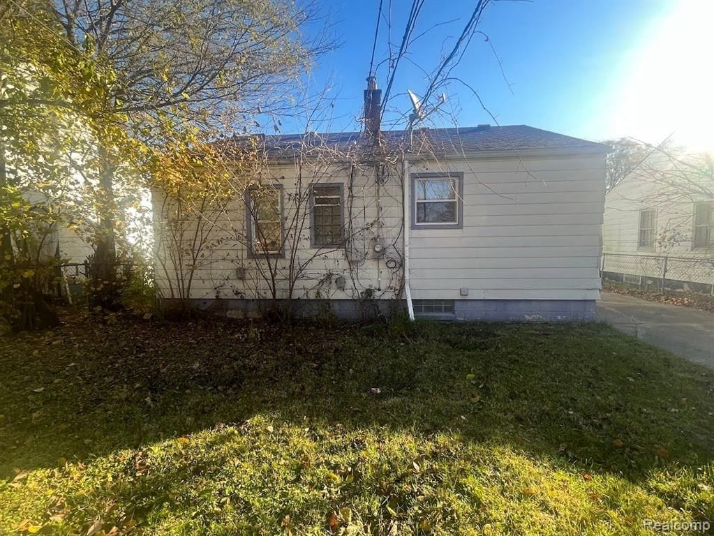 view of property exterior with a lawn