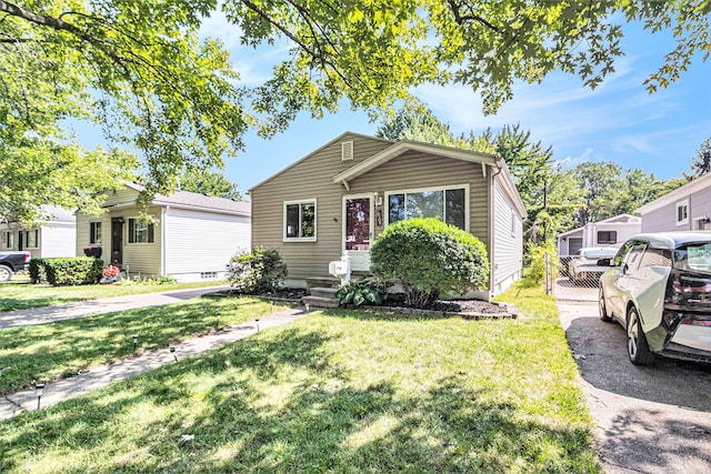 bungalow-style home featuring a front lawn