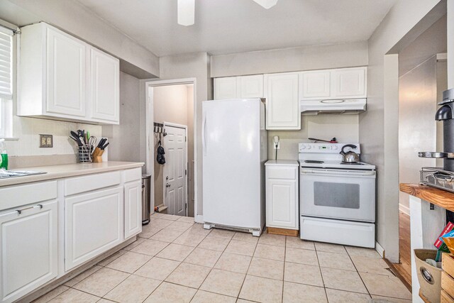 kitchen featuring white cabinetry, light tile patterned floors, and white appliances