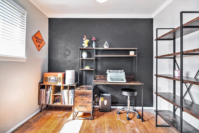 home office with a wealth of natural light, wood-type flooring, and ornamental molding