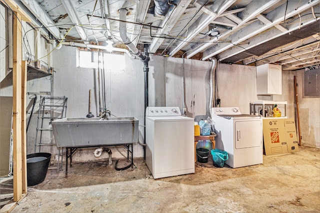 basement with separate washer and dryer, sink, and electric panel