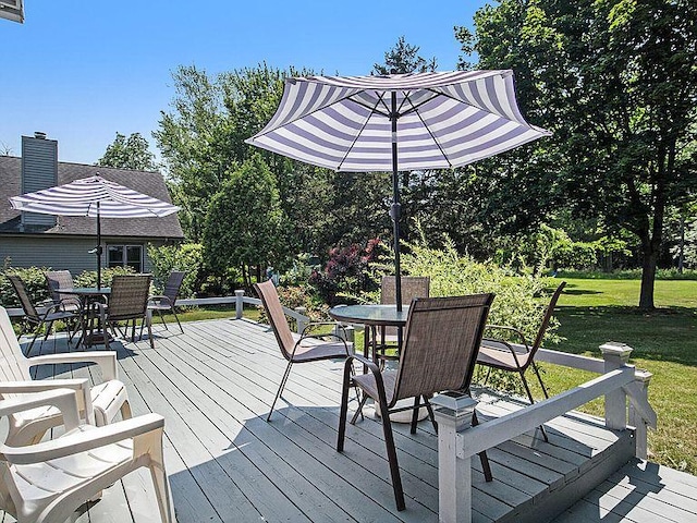 wooden deck featuring a yard