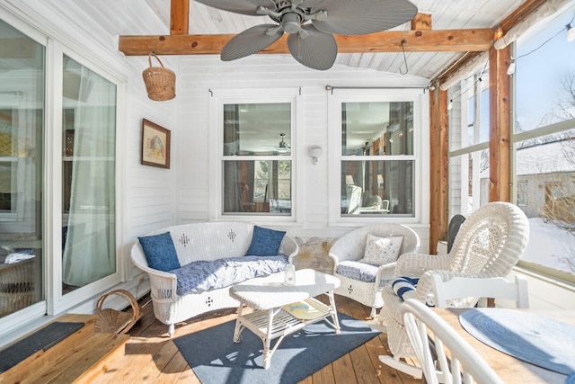 sunroom with vaulted ceiling with beams, ceiling fan, and wooden ceiling