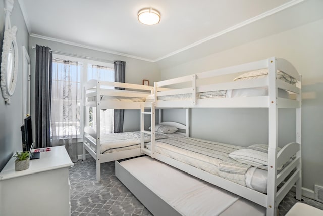 bedroom with crown molding and dark carpet