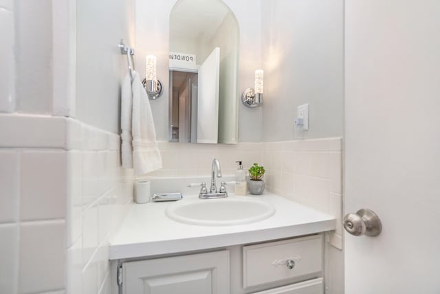 bathroom with vanity and tasteful backsplash