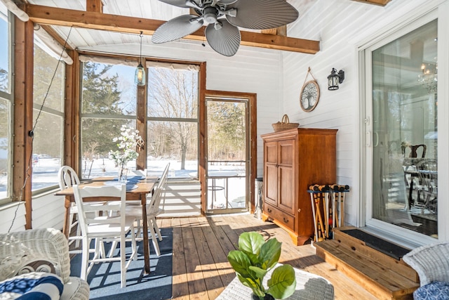 sunroom / solarium with vaulted ceiling with beams, ceiling fan, and wood ceiling