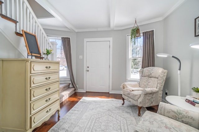 sitting room featuring beamed ceiling, dark hardwood / wood-style flooring, and crown molding