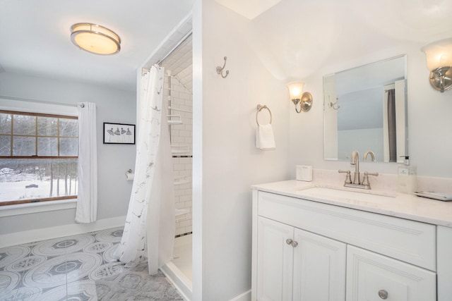 bathroom with tile patterned flooring, vanity, and walk in shower