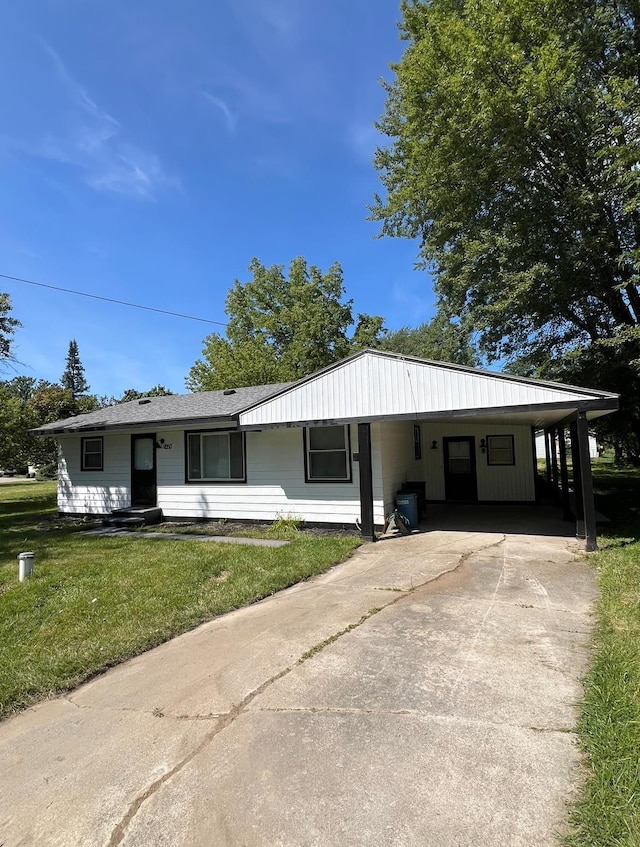 view of front facade with a front yard and a carport