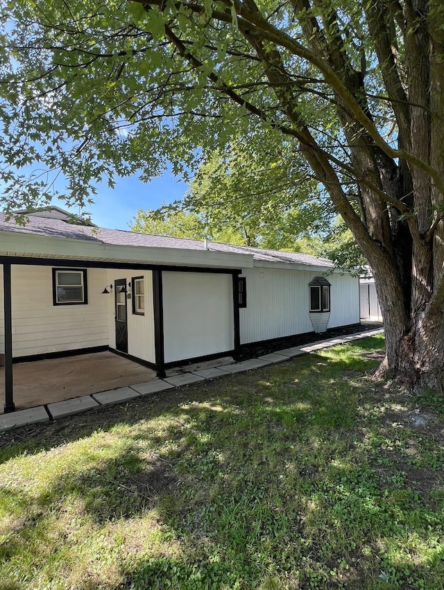 view of home's exterior featuring a lawn and a patio area