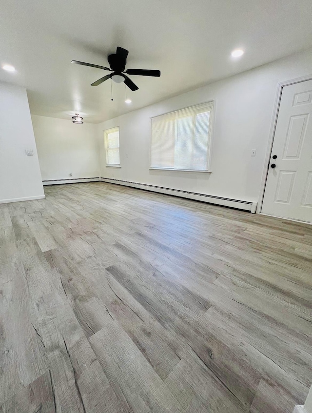 spare room with ceiling fan, light hardwood / wood-style flooring, and plenty of natural light