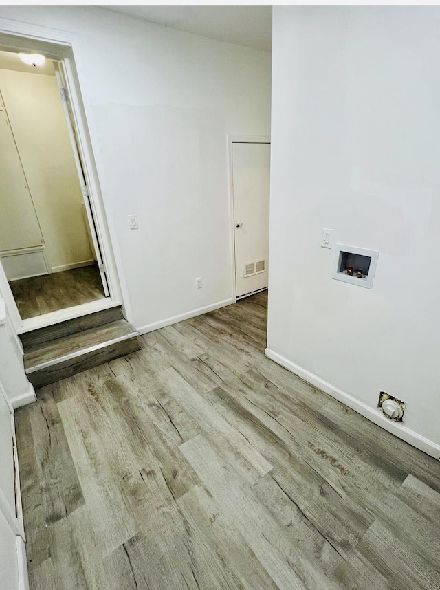 laundry room with hookup for a washing machine and light wood-type flooring