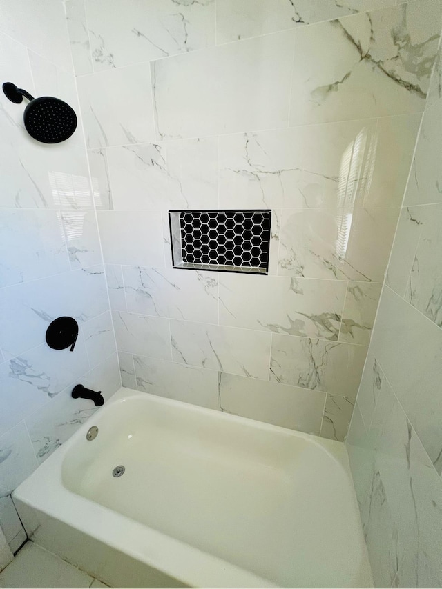 bathroom featuring tiled shower / bath