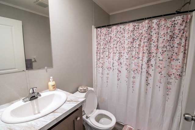 bathroom featuring vanity, toilet, and crown molding