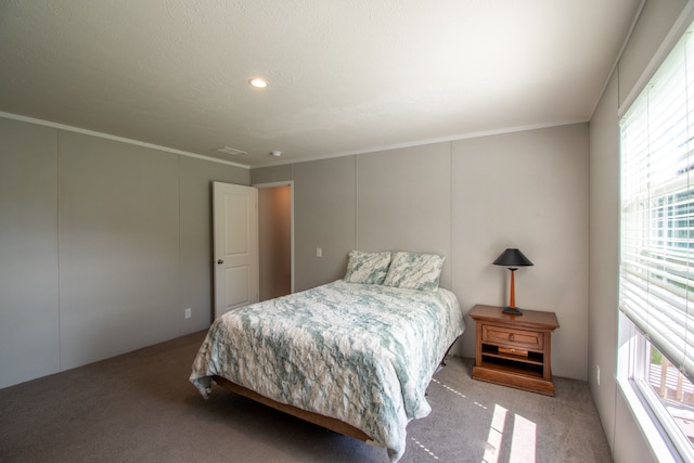 bedroom with light colored carpet, multiple windows, and ornamental molding