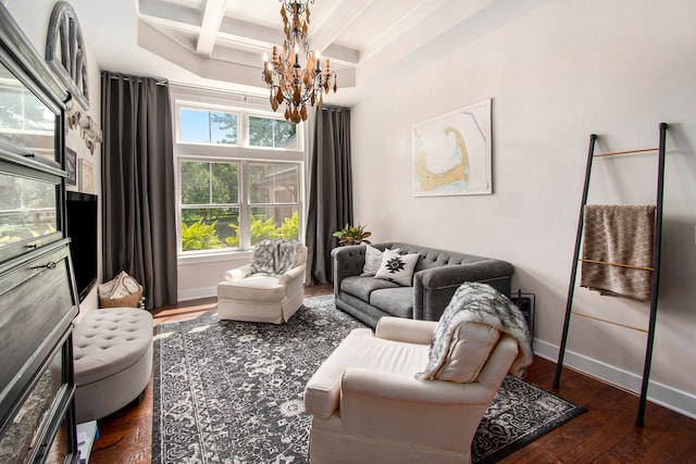 living room with beamed ceiling, dark hardwood / wood-style flooring, a notable chandelier, and coffered ceiling