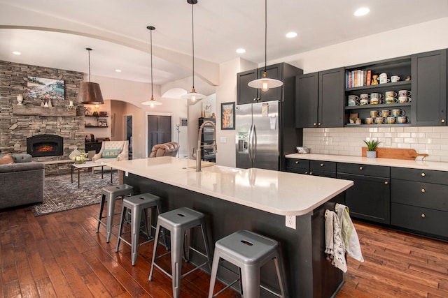 kitchen with dark hardwood / wood-style floors, a kitchen bar, and hanging light fixtures