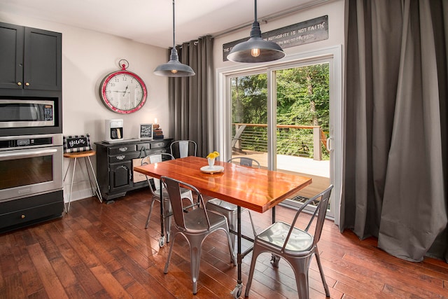 dining area featuring dark wood-type flooring