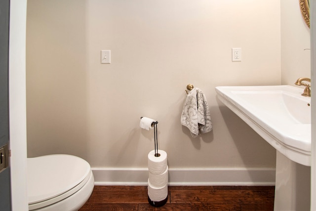 bathroom featuring hardwood / wood-style floors, toilet, and sink