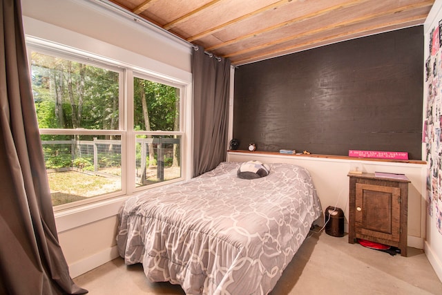 carpeted bedroom featuring wood ceiling and multiple windows