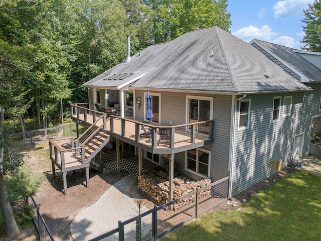 rear view of property featuring a wooden deck