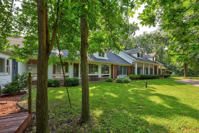 4705 Weiss Rd, Frankenmuth, MI 48734 - cape cod house with a front lawn, brick siding, and a shingled roof