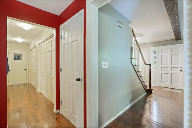 4705 Weiss Rd, Frankenmuth, MI 48734 - hall featuring hardwood / wood-style floors, stairs, and baseboards