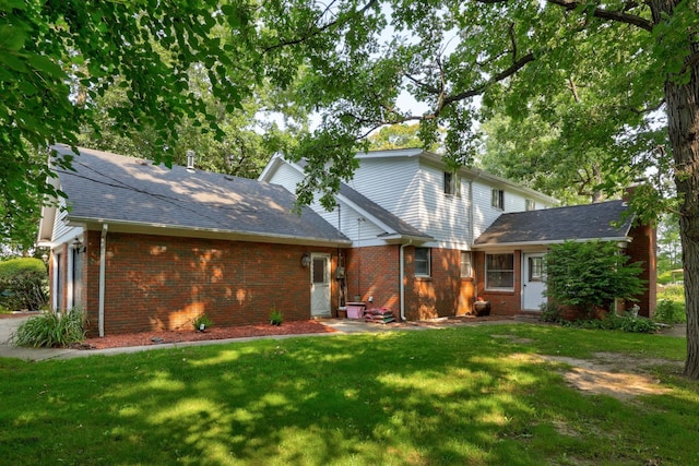 4705 Weiss Rd, Frankenmuth, MI 48734 - view of front of house with a front yard, brick siding, an attached garage, and a shingled roof