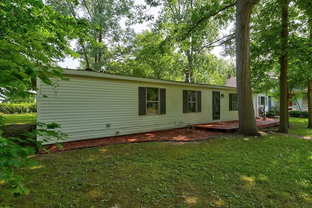 rear view of house featuring a yard