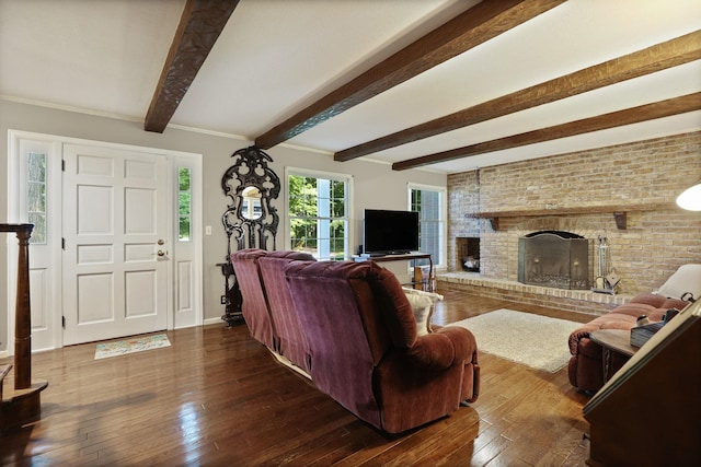 living room with brick wall, crown molding, dark wood-type flooring, beam ceiling, and a fireplace