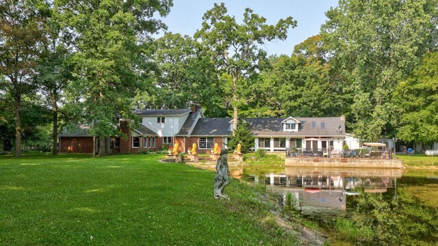 4705 Weiss Rd, Frankenmuth, MI 48734 - back of house with a lawn and a water view